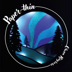 Paper thin album cover. Papercut artwork of Silhouetted pine trees in the foreground with the northern lights in the background